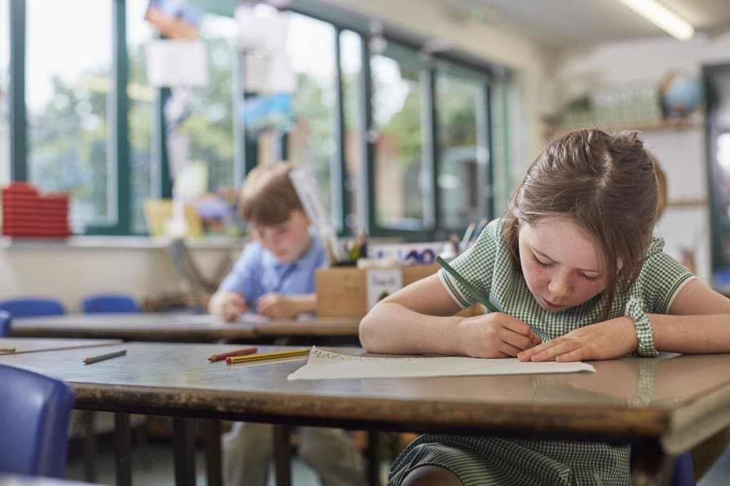 schoolgirl writing in classroom lesson in primary 2022 03 04 01 52 37 utc